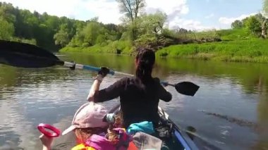 Family kayak trip. Mom and daughter rowing a boat on the river, a water hike, a summer adventure. Eco-friendly and extreme tourism, active and healthy lifestyle