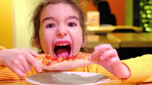 Pięcioletnia Dziewczynka Jest Zabawna Jedząc Kawałek Pizzy Kawiarni Rękami Żując — Wideo stockowe