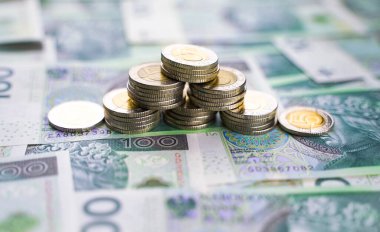 Background from money. Polish banknotes. 100 paper zloty and coins