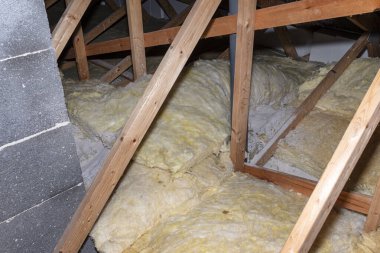 Glass wool placed on pipes in domestic ventilation with heat recovery, pipes placed on a roof truss.