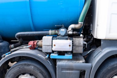 A truck with a large tank for pumping out a septic tank with a capacity of more than 20 cubic meters, large suction pump visible.