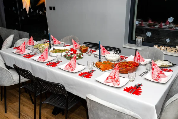 A table set before Christmas dinner with many traditional Polish dishes.
