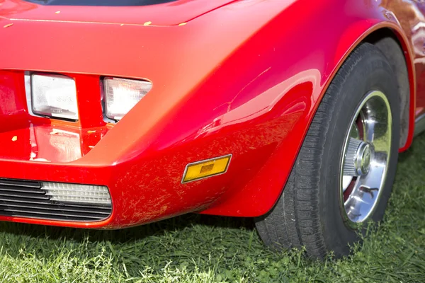 Left front fender red car parked in a meadow — Stock Photo, Image