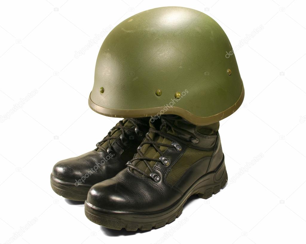 Soldier and army attributes: military boots and helmet. Isolated on white background. Clipping path (without shadow).