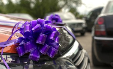 The car decorated with bows as a gift or a wedding cortege car clipart