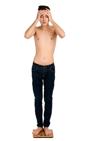 Ung man orolig för hans vikt. — Stockfoto
