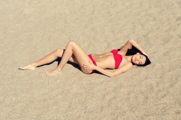 Vacker perfekt brunett kvinna njuter av sin tid på stranden, på sanden — Stockfoto