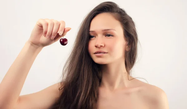 Beautiful woman posing with a cherry — Stock Photo, Image