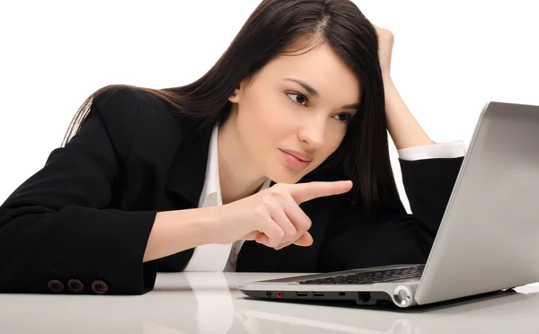Beautiful brunette businesswoman working on a laptop at her office — Stock Photo, Image