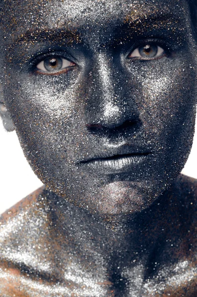 Beautiful face of a woman covered in glitter Close up of a woman's face covered in silver glitter — Stock Photo, Image