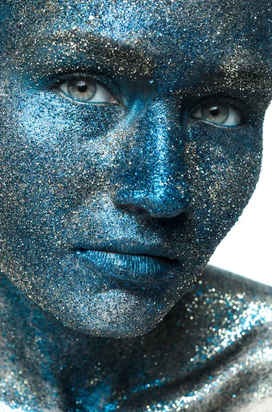 Beautiful face of a woman covered in glitter Close up of a woman's face covered in silver glitter — Stock Photo, Image