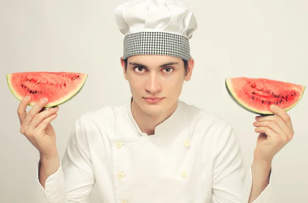Portrait of a beautiful chef and a slice of a green melon — Stock Photo, Image
