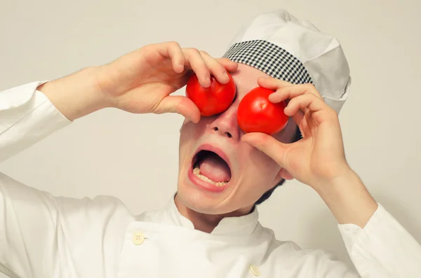 Chef drôle jouant avec des tomates et criant — Photo