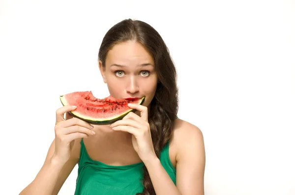 Beautiful woman eating a green ripe melon slice — Stock Photo, Image