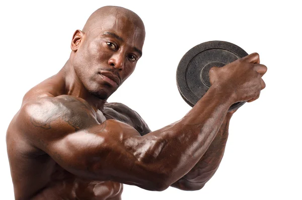 Black bodybuilder posing with round discs. Strong man with perfect abs, shoulders,biceps, triceps and chest. Isolated on white background — Stock Photo, Image