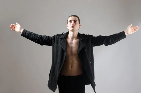 Young man raising his arms up, praying — Stock Photo, Image