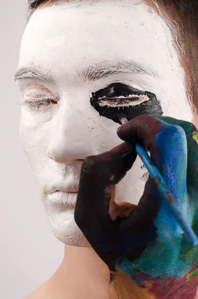 Beautiful young man painted on the face, preparing for Halloween — Stock Photo, Image