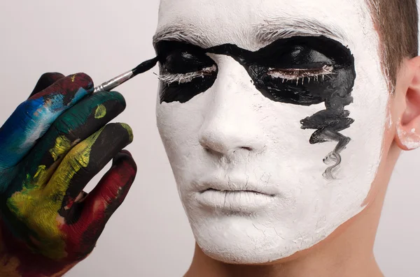 Beautiful young man painted on the face, preparing for Halloween — Stock Photo, Image