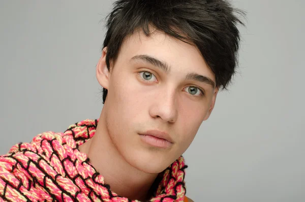 Portrait of an innocent handsome man posing fashion with colored scarf. Young guy with cool messy hairstyle — Stock Photo, Image