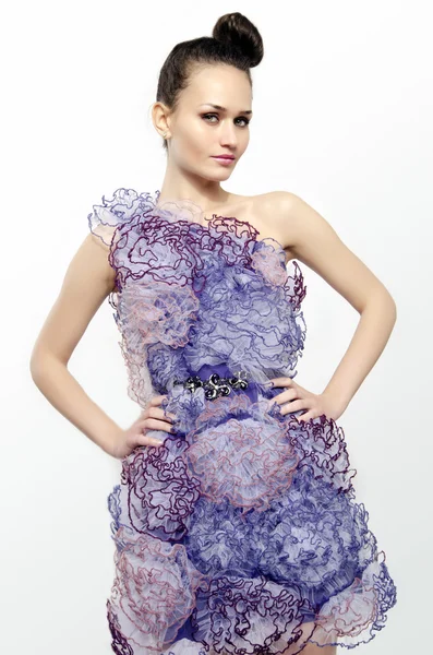 Beautiful woman wearing a purple dress with lace flowers and holding her hand on her hips. Girl posing fashion — Stock Photo, Image