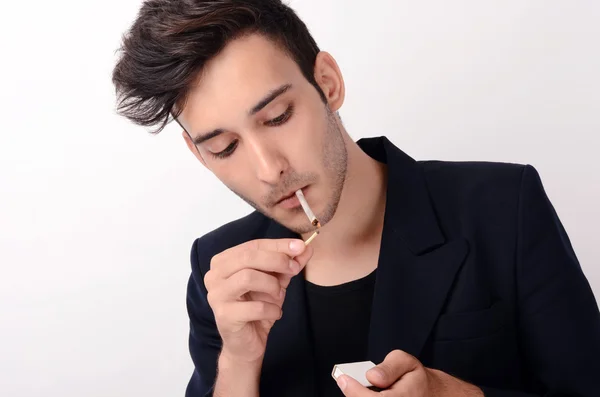 Young beautiful businessman smoking a cigar — Stock Photo, Image