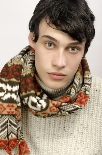 Portrait of a beautiful man wearing sweater, gloves, scarf and a hat, dressed for winter cold, smilling — Stock Photo, Image