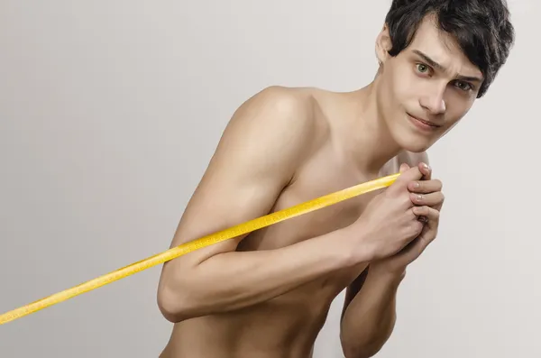 Skinny young man posing fashion with a centimeter, anorexic look. Slim body — Stock Photo, Image