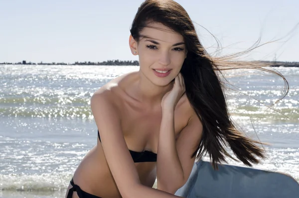 Beautiful woman enjoying her time on the beach on a sunny perfect day, sexy woman in swimsuit getting a tan — Stock Photo, Image