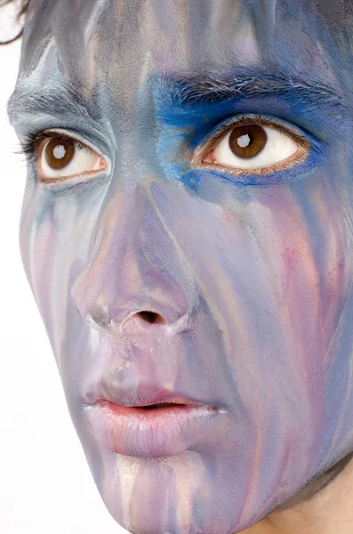 Beautiful young man painted on the face with many colours — Stock Photo, Image