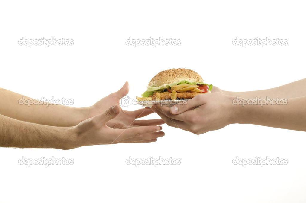 Hands offering a big hamburger and hungry hands ready to receive,isolated on white