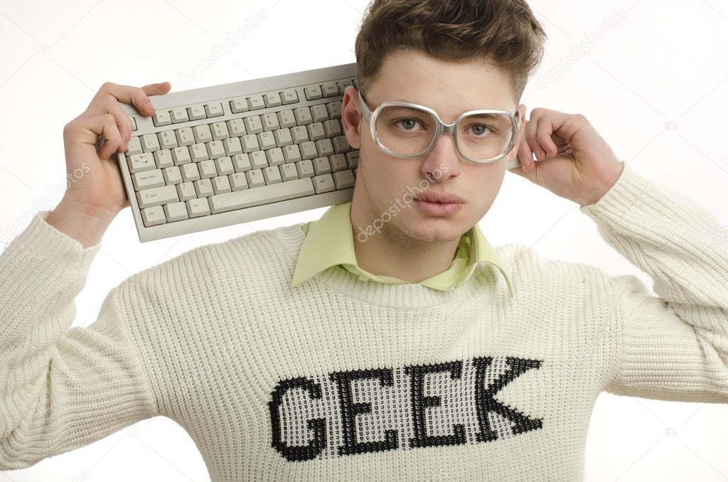 Geek playing video games with a keyboard, gamer wearing eyeglasses