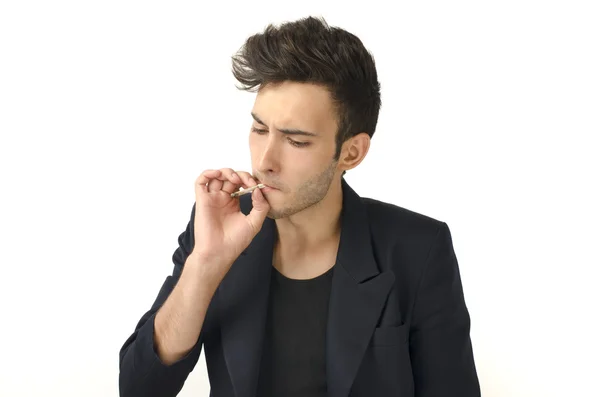 Young beautiful businessman smoking a cigar, tabacco addiction — Stock Photo, Image