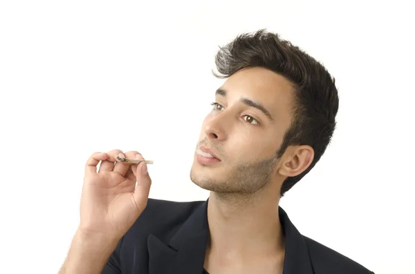 Young beautiful businessman smoking a cigar, tabacco addiction — Stock Photo, Image