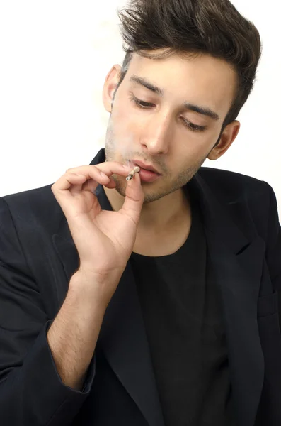 Young beautiful businessman smoking a cigar, tabacco addiction — Stock Photo, Image