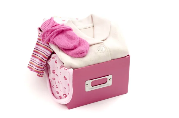 Close up of a box full with baby pink clean clothes isolated — Stock Photo, Image