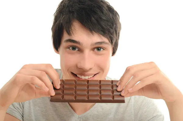 Hombre feliz comiendo un delicioso chocolate y teniendo un poco de azúcar para un día activo — Foto de Stock