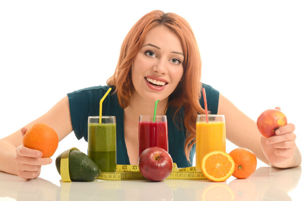 Happy woman holding in front of her three different smoothie. Cheerful young woman eating healthy salad, fruits , orange juice and green smoothie