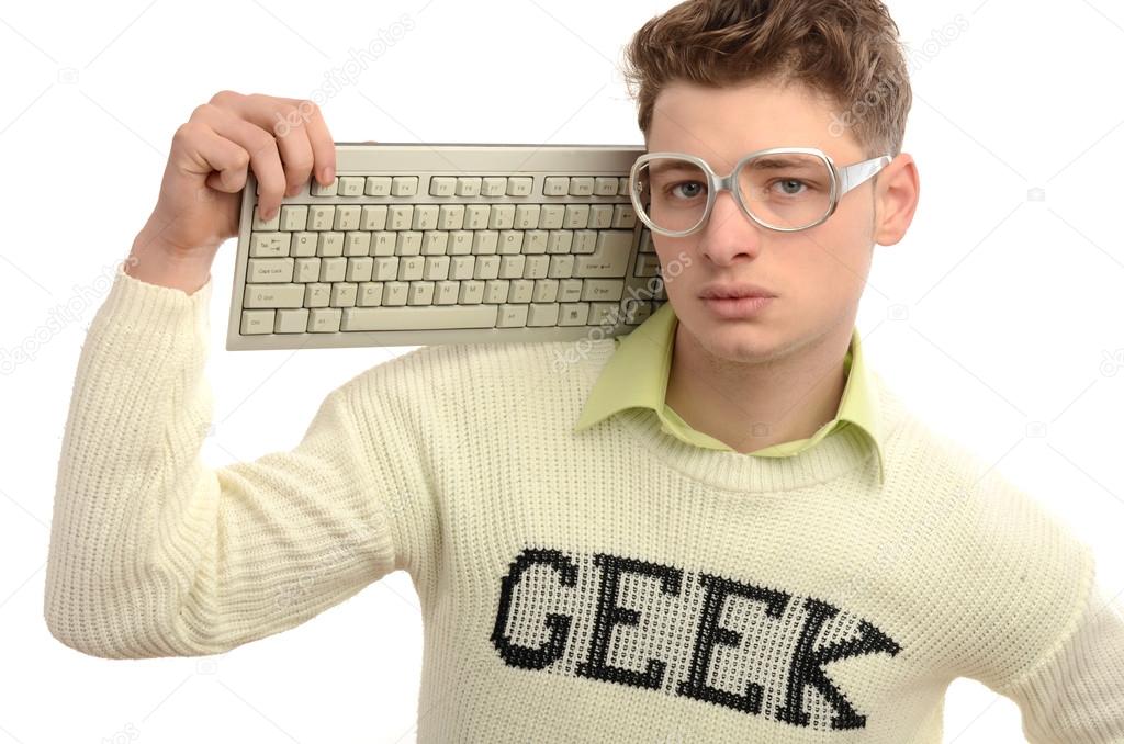 Geek playing video games with a keyboard, gamer wearing eyeglasses