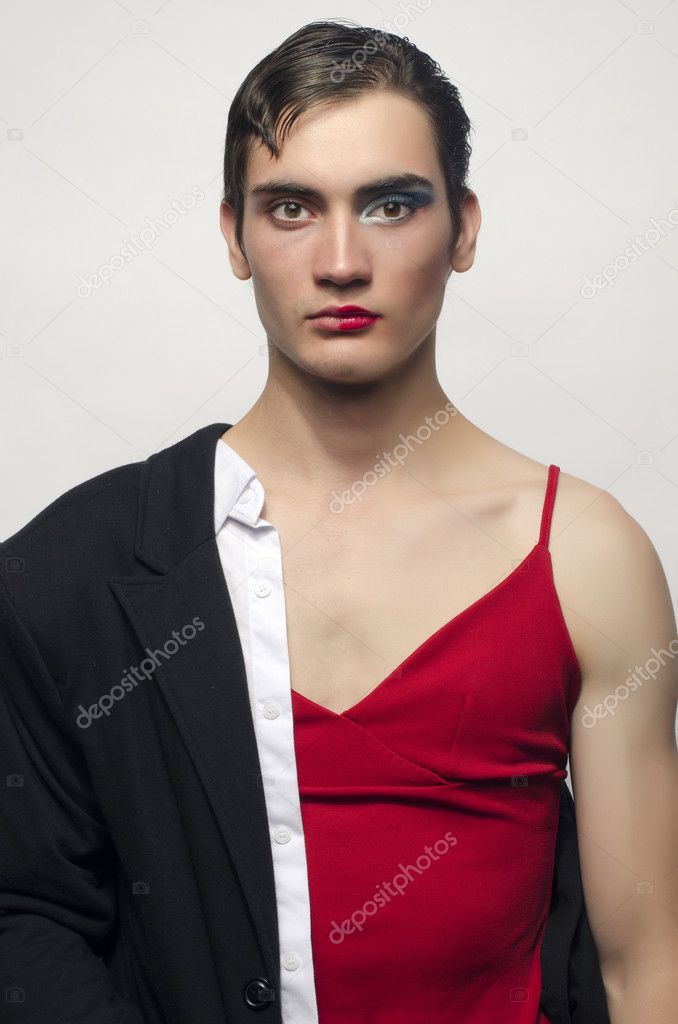 Half man, half woman, wearing a black suit and a red dress.Angry man wearing make up, Portrait of a drag queen.