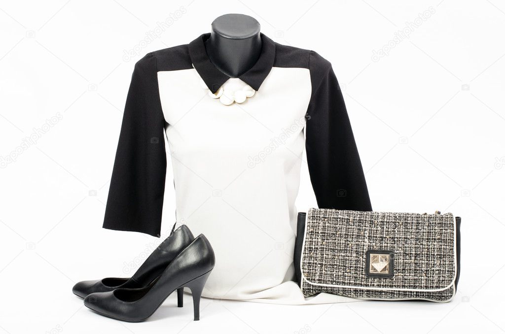 Black and white blouse on mannequin with matching accessories. Elegant blouse on tailor's dummy with matching purse,high heels and necklace