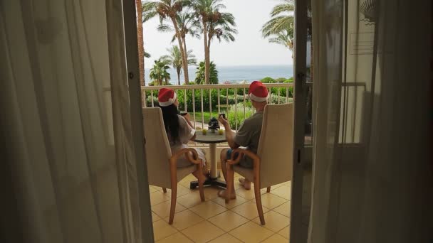 Married Couple Santa Claus Hats Celebrates Christmas Balcony Sea Drink — Stock Video