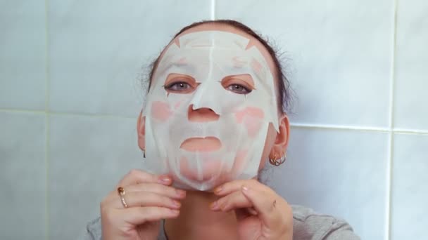 Woman Face Tissue Mask Her Face Hands Patting Massage Medium — Stock Video