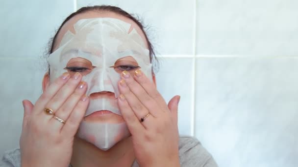 Woman Sheet Mask Her Face Hands Doing Patting Massage Medium — Stock Video