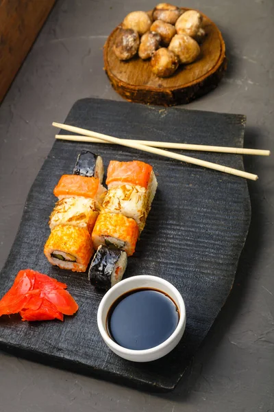 Rolls Black Carved Board Next Soy Sauce Ginger Baked Mushrooms — Stock Photo, Image