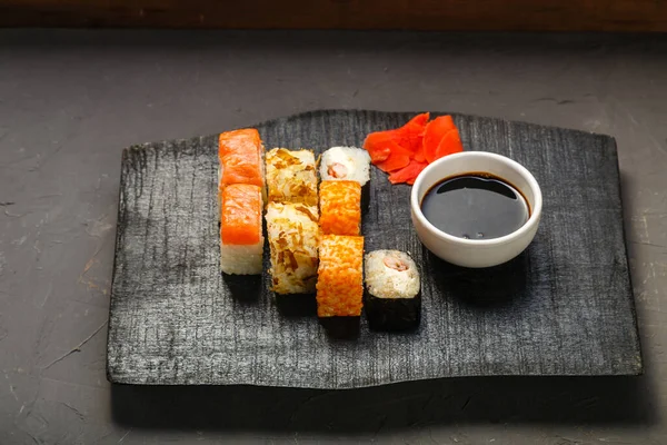 Assorted Salmon Shrimp Rolls Black Carved Board Next Soy Sauce — Stock Photo, Image
