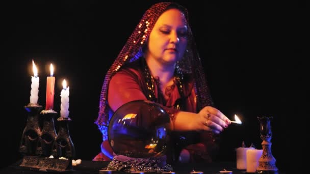 Fortune Teller Red Dress Lights Candles Black Background Overall Plan — Stock Video