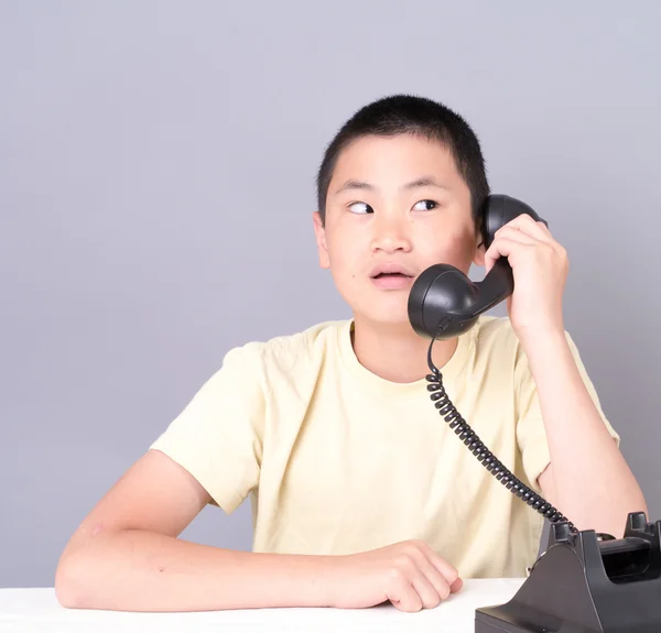 Азиатский подросток на ретро-телефоне — стоковое фото
