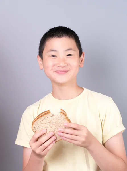 Tiener jongen genieten van een sandwich — Stockfoto