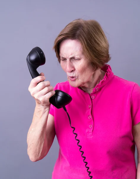 Older Woman Dealing with a rude caller — Stok fotoğraf