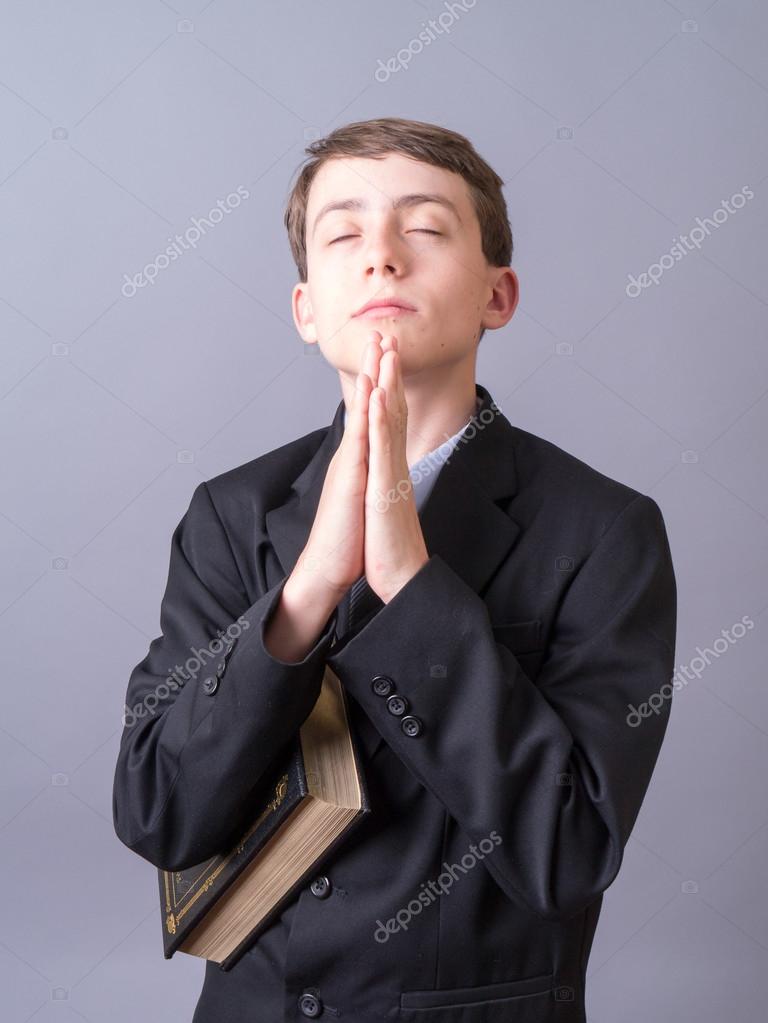 Christian Boy Praying Holding the Bible — Stock Photo 12573260